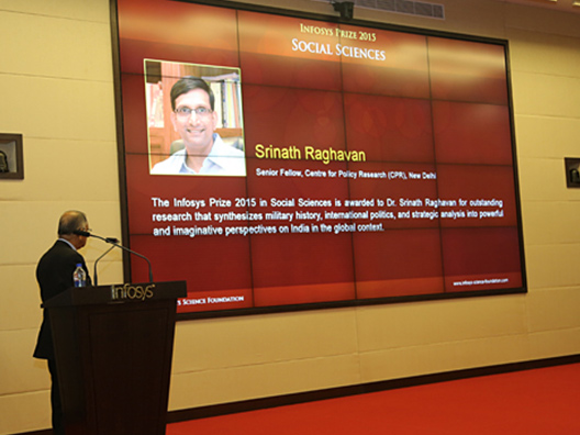 Trustee Narayana Murthy looks on as winner of Social Sciences Prize responds