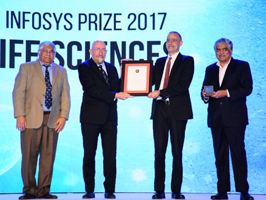 Prof Upinder Bhalla receiving the Infosys Prize 2017 from Nobel Laureate Prof Kip Thorne with Prof Inder Verma and Mr Nandan Nilekani