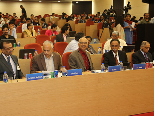School students and media wait to hear Trustees of the ISF announce Infosys Prize 2015 winners