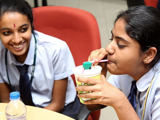 Students attempting fluid flow experiments during the science workshop