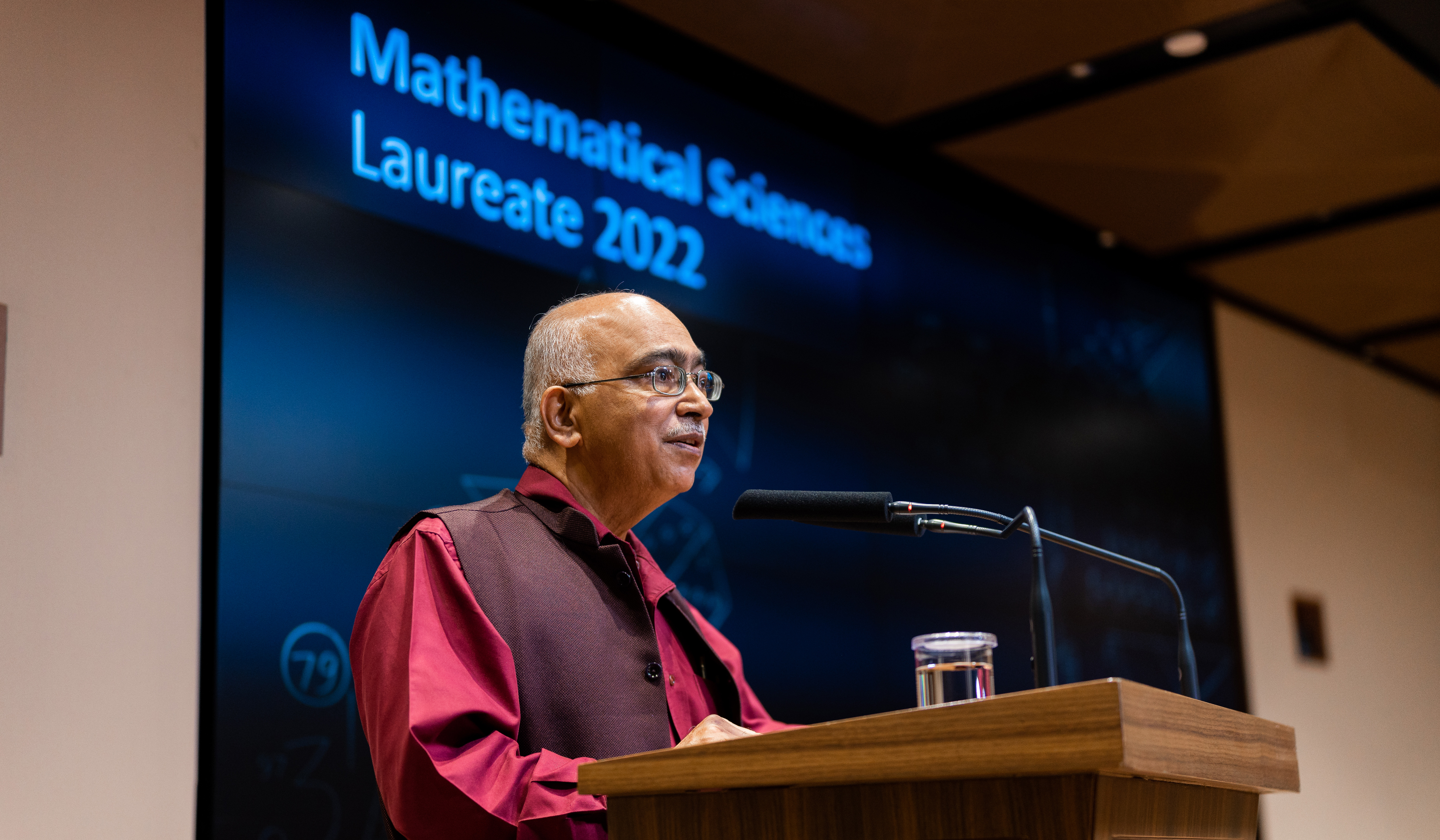 Anchor trustee K. Dinesh announcing the Infosys Prize 2022 in Mathematical Sciences