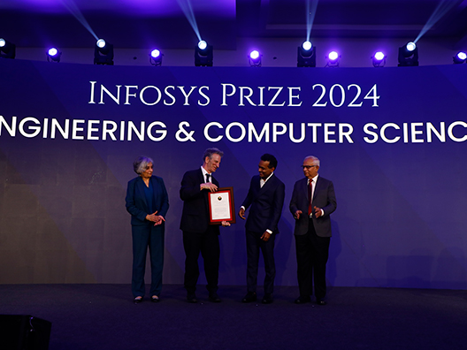 Prof. Jayathi Murthy, Prof. Peter Sarnak, and Mr. Srinath Batni presenting the Infosys Prize 2024 to Prof. Shyam Gollakota