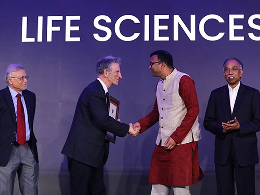 Prof. Mriganka Sur, Prof. Peter Sarnak, and Mr. S.D. Shibulal presenting the Infosys Prize 2024 to Prof. Siddhesh Kamat
