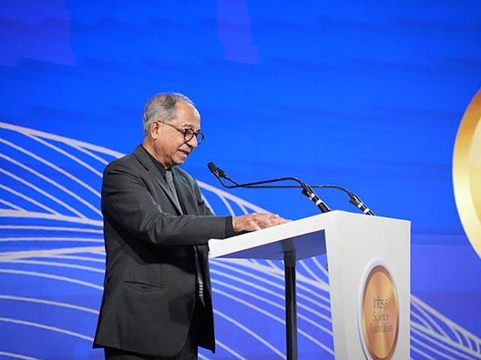 Prof. Kaushik Basu reading the jury’s citation of Prof. Nikhil Agarwal’s work at the Infosys Prize Ceremony 2025
