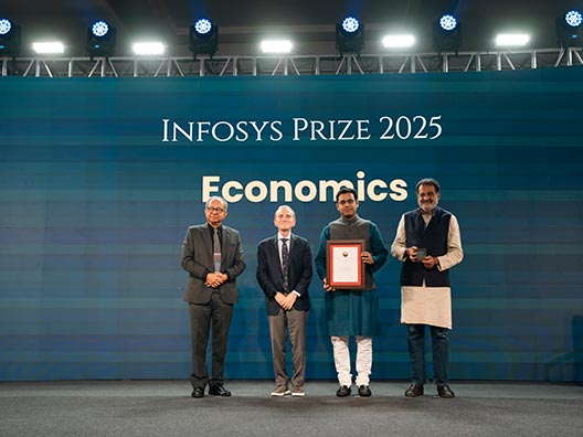 Prof. Kaushik Basu, Prof. Randy Schekman, and Mr. Mohandas Pai presenting the Infosys Prize 2024 to Prof. Nikhil Agarwal