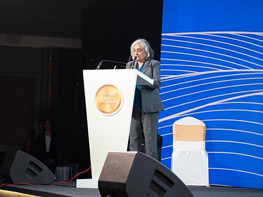 Prof. Jayathi Murthy reading the jury’s citation of Prof. Sushant Sachdeva’s work at the Infosys Prize Ceremony 2025
