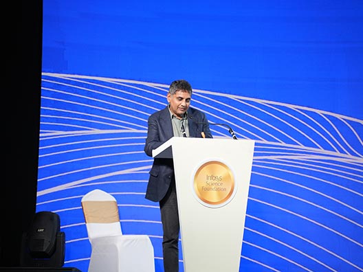 Prof. Chandrashekhar Khare reading the jury’s citation of Prof. Sabyasachi Mukherjee’s work at the Infosys Prize Ceremony 2025