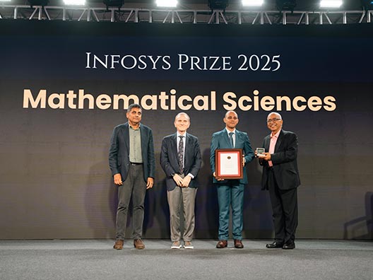 Prof. Chandrashekhar Khare, Prof. Randy Schekman, and Mr. K. Dinesh presenting the Infosys Prize 2025 to Prof. Sabyasachi Mukherjee